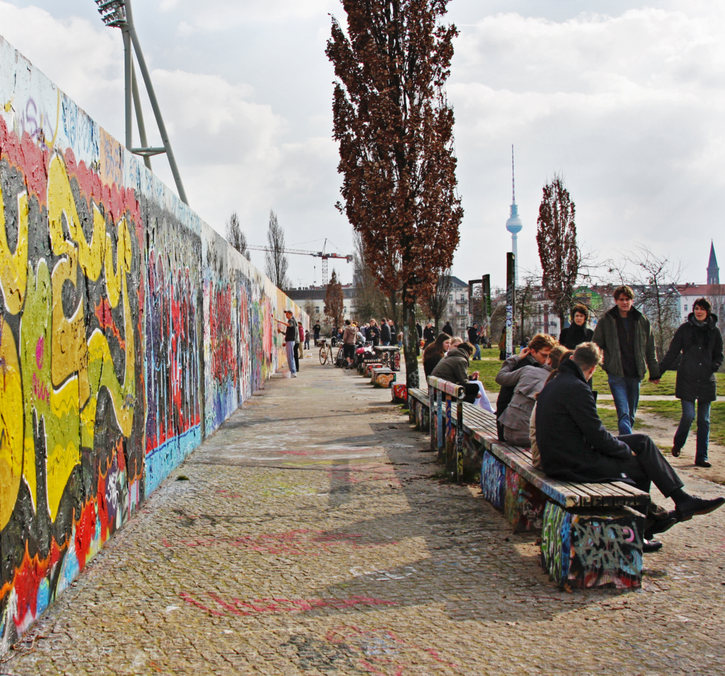 A picture of tourists visiting the Berlin Wall. 