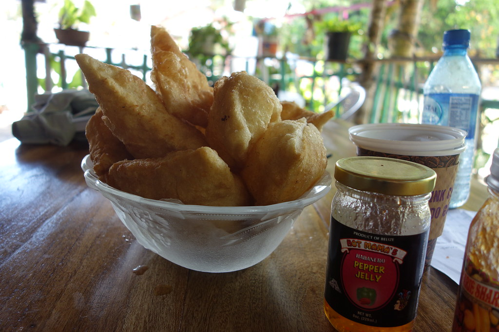 An image of fry jacks in Belize served with different jams and coffee.