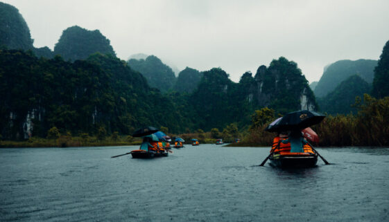 An image of tourists on boats in Ninh Binh, Vietnam