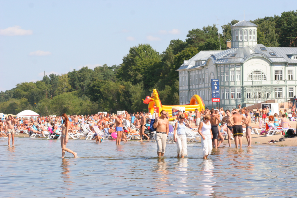 An image of tourists and locals visiting Jurmala Beach.