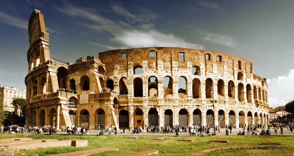 An image of tourists visiting the Colosseum, one of many attractions in senior travels to Rome. 
