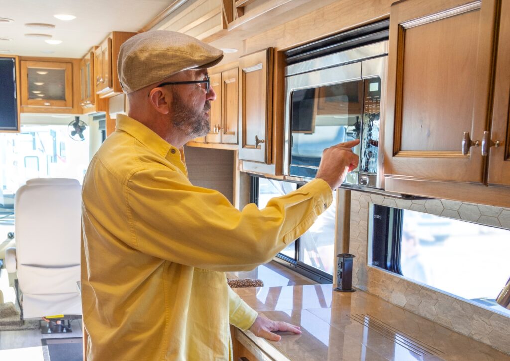 a Senior pointing at a microwave